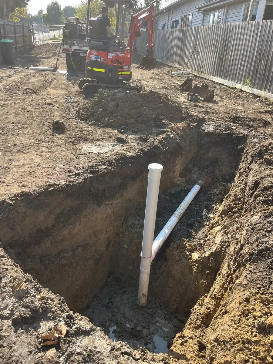 Exposed drain pipe in an excavation, Elwood